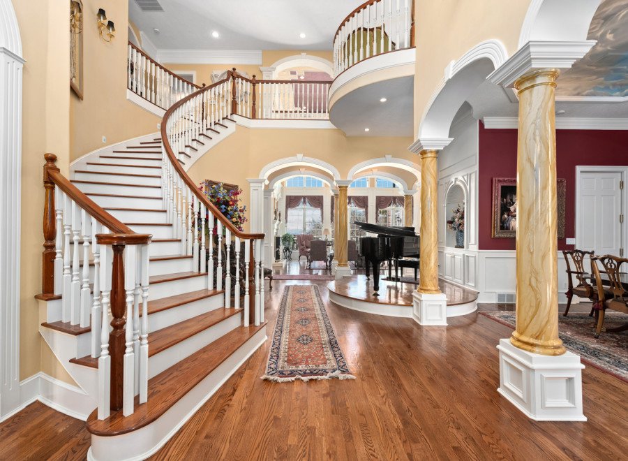 Step into luxury with this stunning property featuring a grand staircase and elegant design.