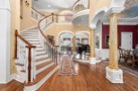 Step into luxury with this stunning property featuring a grand staircase and elegant design.