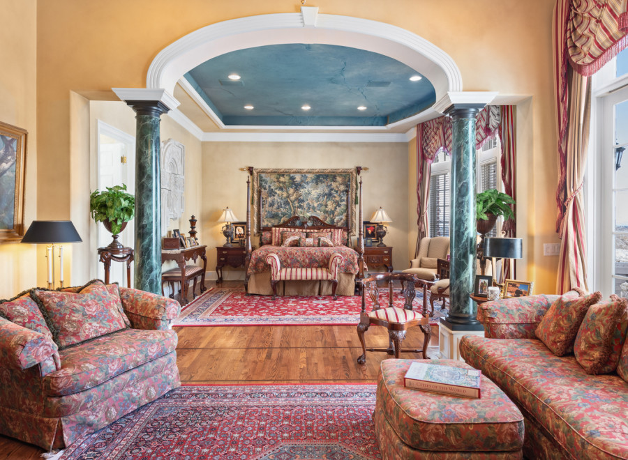 Step into luxury with this exquisite bedroom, boasting elegant columns and a stunning arched ceiling.