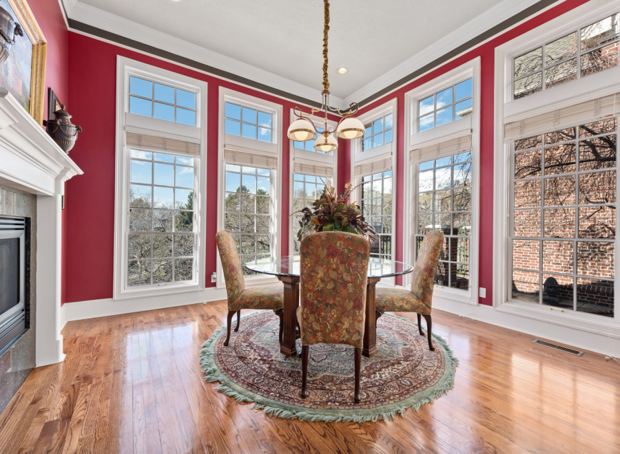 This elegant dining room boasts a stunning array of windows, offering panoramic views and abundant natural light.