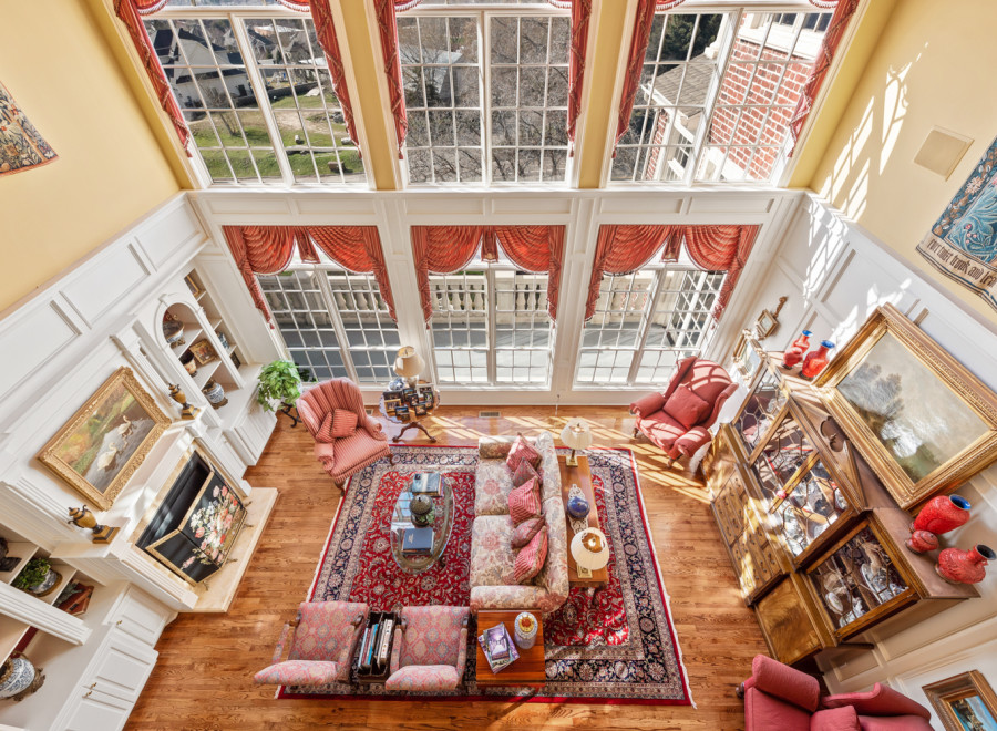 Experience luxury living in this stunning property, featuring a grand living room with soaring ceilings and abundant natural light.
