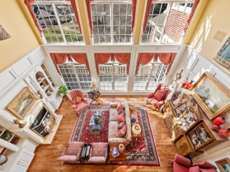 Experience luxury living in this stunning property, featuring a grand living room with soaring ceilings and abundant natural light.