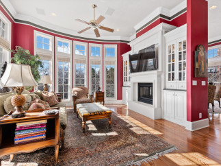 Step into luxury with this stunning living room! Featuring a cozy fireplace, elegant built-ins, and a beautiful rug, this space is perfect for relaxation and entertaining.