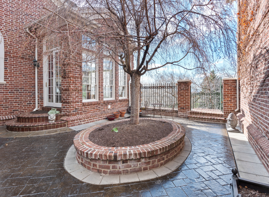 Discover the charm of this brick-walled patio, perfect for outdoor relaxation.