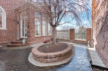 Discover the charm of this brick-walled patio, perfect for outdoor relaxation.