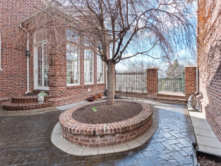 Discover the charm of this brick-walled patio, perfect for outdoor relaxation.