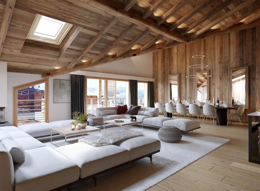 Experience luxury living in this stunning chalet, featuring a spacious open-plan living area with a cozy fireplace and a modern kitchen.