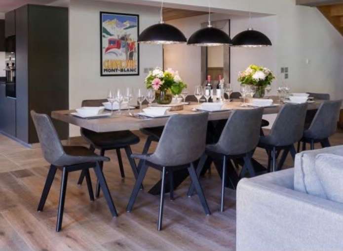 This stunning property boasts a spacious open-plan living area with a large dining table perfect for entertaining.