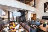 This stunning chalet boasts a spacious open-plan living area with a modern kitchen and a cozy dining area perfect for family gatherings.