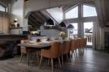 This stunning chalet boasts a spacious open-plan living area with a large dining table perfect for gatherings.
