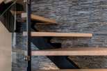Modern floating staircase with sleek metal accents and light oak treads.