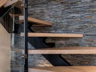 Modern floating staircase with sleek metal accents and light oak treads.