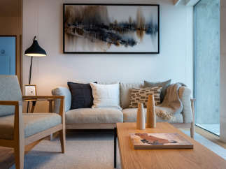 This stunning living room boasts a light and airy feel, thanks to its large windows and neutral color palette.