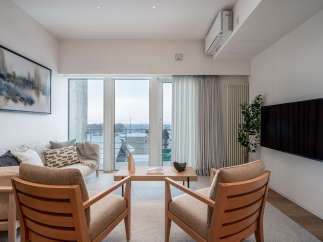 Modern living room with floor-to-ceiling windows offering scenic snowy views.