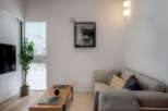 Modern living room with large window offering snowy views, featuring a comfortable corner sofa, stylish coffee table, and tasteful artwork.