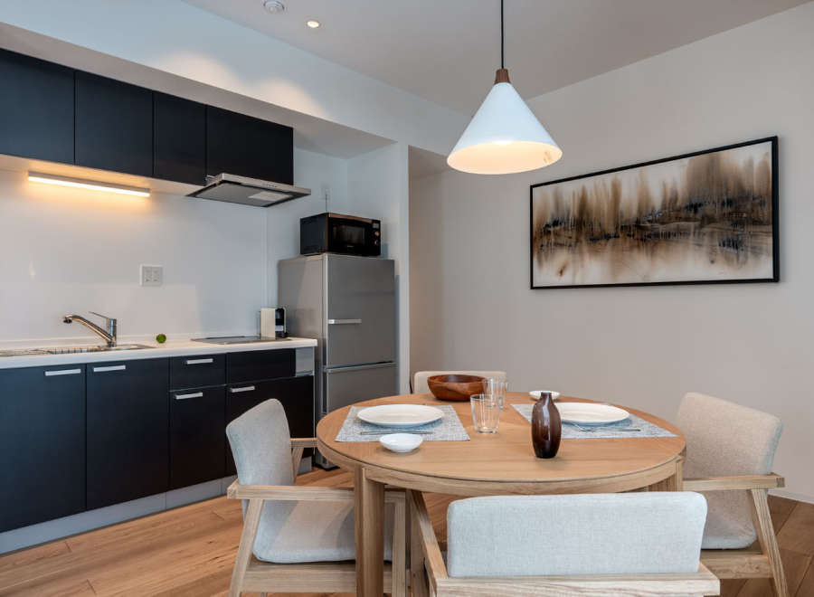 This modern apartment boasts a stylish open-plan kitchen and dining area, perfect for comfortable living.