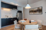 This modern apartment boasts a stylish open-plan kitchen and dining area, perfect for comfortable living.