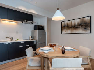 This modern apartment boasts a stylish open-plan kitchen and dining area, perfect for comfortable living.