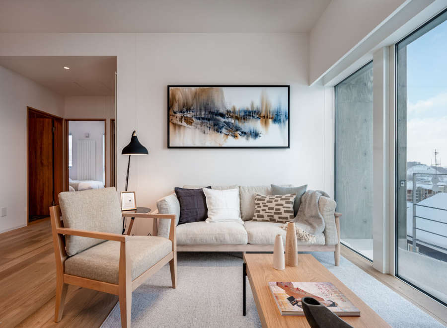 This stunning living room boasts a light and airy atmosphere, highlighted by large windows offering breathtaking views and ample natural light.