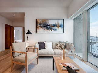 This stunning living room boasts a light and airy atmosphere, highlighted by large windows offering breathtaking views and ample natural light.