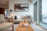 Modern living room with large windows offering stunning views of a snow-covered landscape.