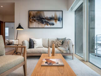Modern living room with large windows offering stunning views of a snow-covered landscape.