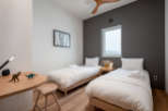 This cozy bedroom features two twin beds with crisp white linens, perfect for a relaxing night's sleep.