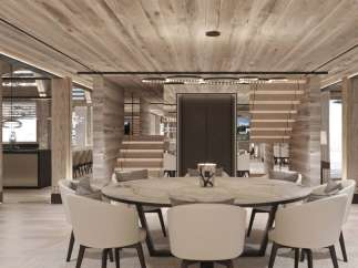This stunning chalet boasts a spacious open-plan living area with a large marble dining table, perfect for entertaining guests.