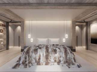 Luxurious mountain retreat boasting a spacious master bedroom with stunning wood beam ceilings and a cozy, plush throw blanket.