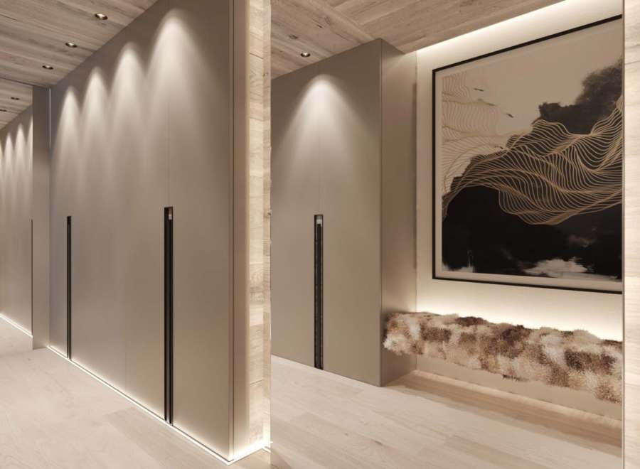 This stunning hallway boasts a sleek, modern design with built-in storage and ambient lighting.