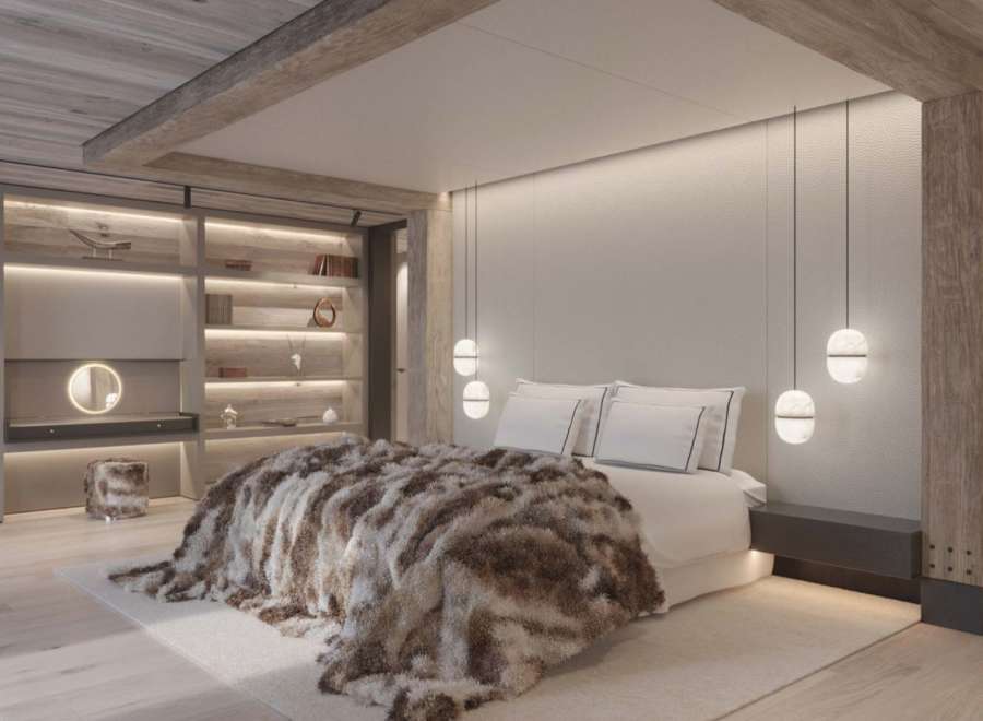 Luxurious mountain retreat boasting a stunning master bedroom with a cozy fur throw, built-in shelving, and modern pendant lighting.