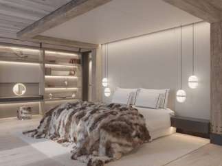 Luxurious mountain retreat boasting a stunning master bedroom with a cozy fur throw, built-in shelving, and modern pendant lighting.