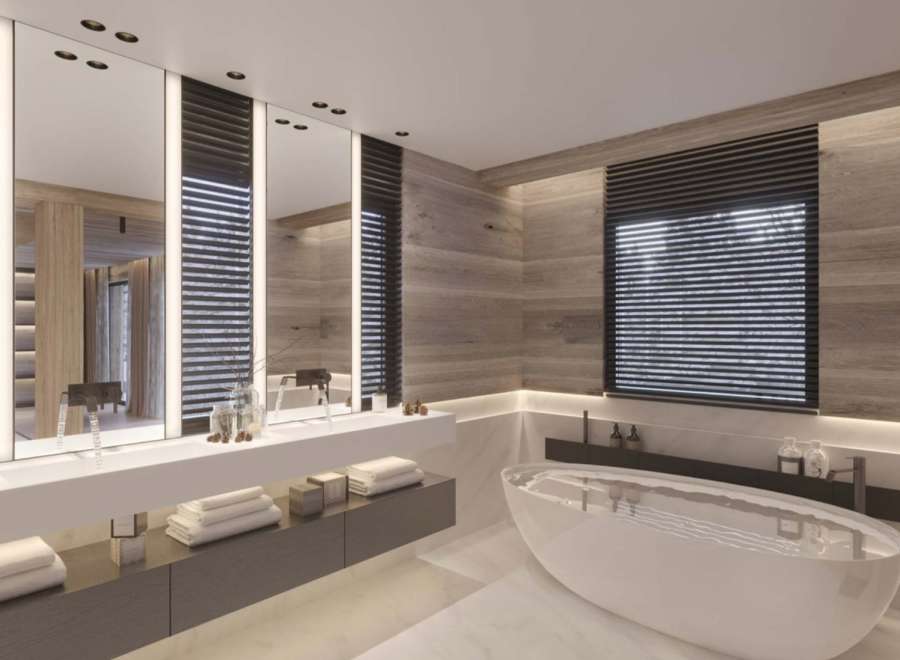 Luxurious bathroom with a freestanding bathtub and double vanity, featuring sleek modern design and wood paneling.