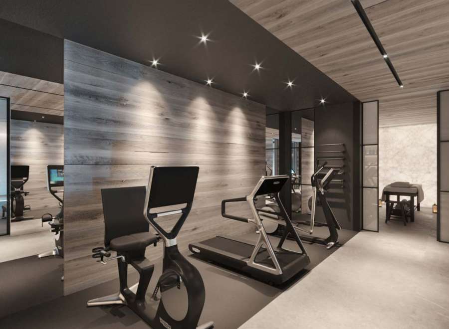 Luxury home gym with state-of-the-art equipment, including treadmills and stationary bikes.