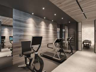 Luxury home gym with state-of-the-art equipment, including treadmills and stationary bikes.