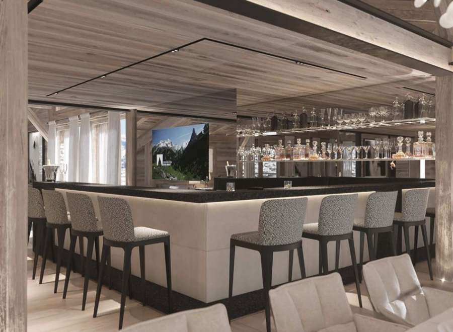 This luxurious chalet boasts a stunning bar area, complete with a sleek design and high-end finishes.