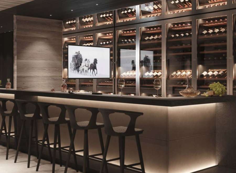 This luxurious home boasts a stunning, built-in wine cellar with glass-front storage, showcasing an impressive collection.