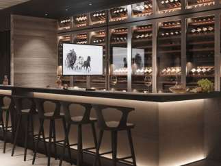 This luxurious home boasts a stunning, built-in wine cellar with glass-front storage, showcasing an impressive collection.