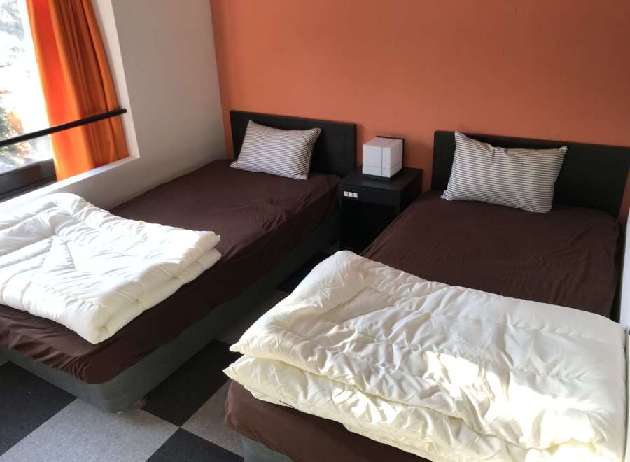 Cozy bedroom with two twin beds, perfect for a comfortable stay.