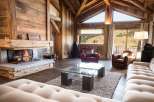 This stunning chalet boasts a spacious open-plan living area with floor-to-ceiling windows offering breathtaking mountain views.
