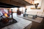 Luxurious chalet living room with a stunning fireplace as the centerpiece.