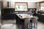 This stunning kitchen boasts a large island with seating for eight, perfect for entertaining.