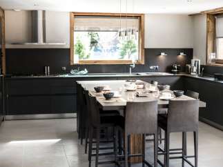 This stunning kitchen boasts a large island with seating for eight, perfect for entertaining.