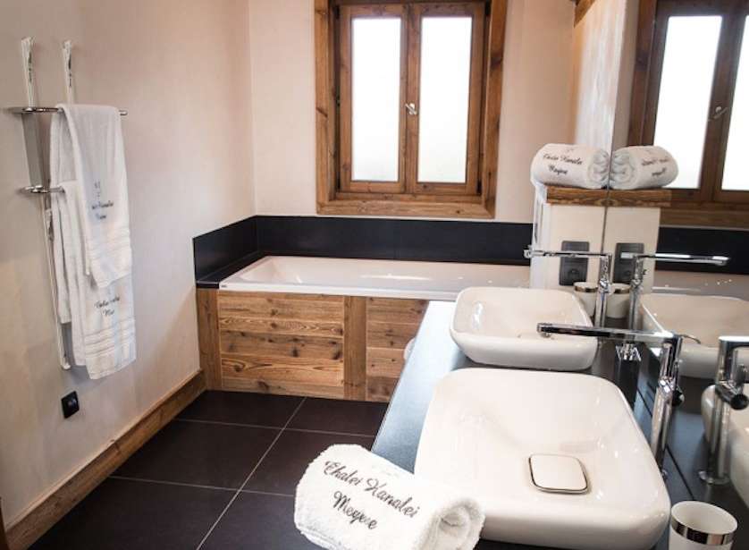 Luxurious bathroom with wooden features and a freestanding bathtub.