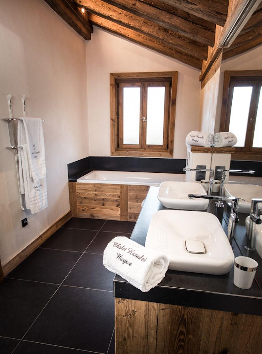 Luxurious bathroom with wooden features and a freestanding bathtub.
