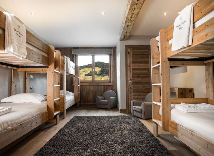 Cozy chalet room with bunk beds, perfect for families or groups.