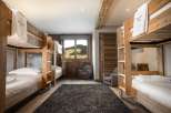 Cozy chalet room with bunk beds, perfect for families or groups.