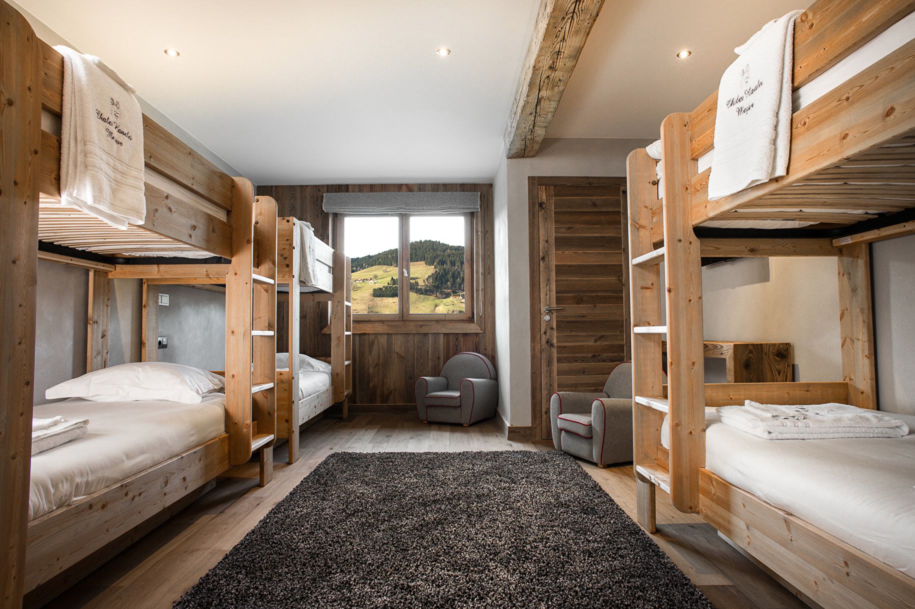 Cozy chalet room with bunk beds, perfect for families or groups.