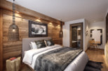 This stunning hotel room boasts a cozy, rustic-chic design with exposed wood walls and a plush bed.