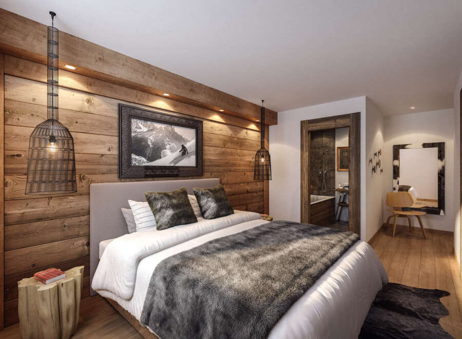 This stunning hotel room boasts a cozy, rustic-chic design with exposed wood walls and a plush bed.